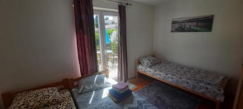 a small room with a bed and a window at Lustica Bay/Radovici in Tivat