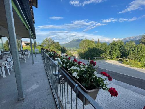 a balcony with flowers on the side of a building at Panoramahotel Sonnhalde in Schwarzenberg im Bregenzerwald