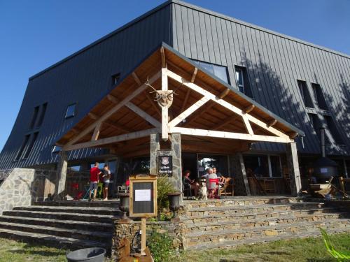 a building with people sitting outside of it at MONTLO RELAIS DES CERFS in Mas-dʼOrcières