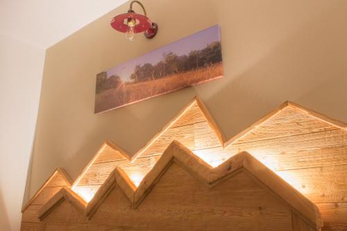 a wooden sign on a wall with a picture on it at Ca' di Pazient in Teglio