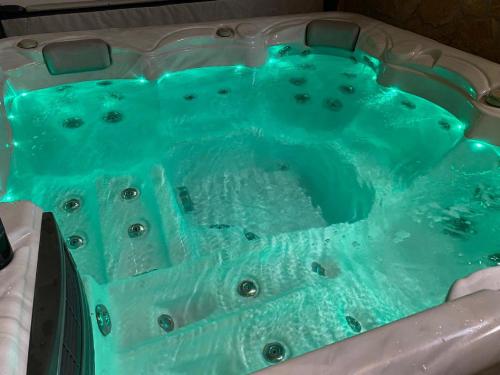 a jacuzzi tub filled with blue water at Villa Mateo with Private Pool in Gruda