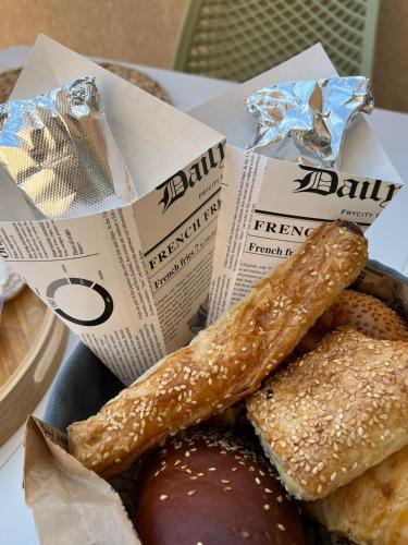 a basket of doughnuts and pastries on a table at lasuita-exclusive suites ceserea-luxury suite in Caesarea