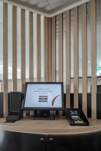 a tv on a table with a screen on it at MOOI Apartments Schlieren in Schlieren