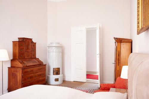 a bedroom with a bed and a dresser and a mirror at Exklusive Suiten im Schloss Horn in Horn