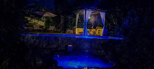 a night view of a house with a gazebo at Casa da Benfeitoria in Guimarães