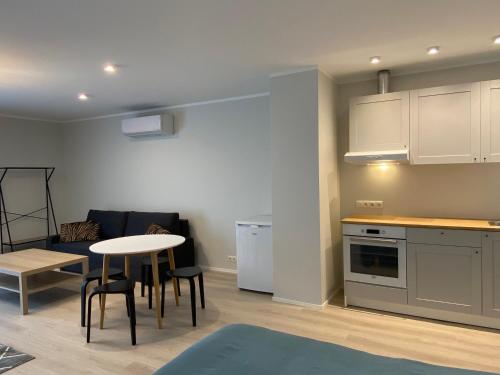 a kitchen and a living room with a table and chairs at Captain's House - Kaptenimaja - Apartments in Kärdla
