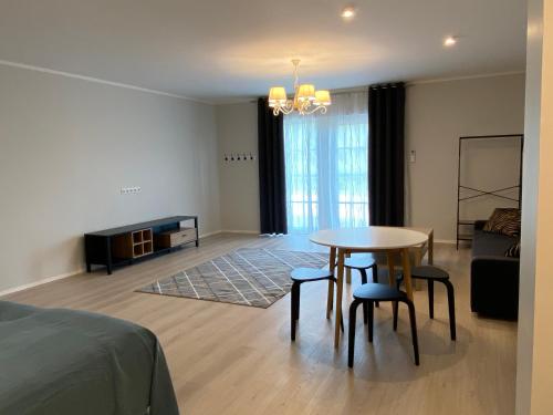 a living room with a table and chairs and a couch at Captain's House - Kaptenimaja - Apartments in Kärdla
