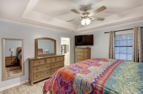 a bedroom with a bed and a dresser and a mirror at Pooler Travelers Retreat I - Entire House - in Savannah
