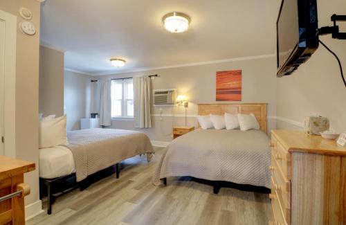 a hotel room with two beds and a television at On the Beach Motel in Old Orchard Beach