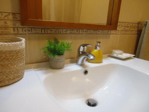 a bathroom sink with a faucet and a mirror at Casa da Pedralva in Nazaré