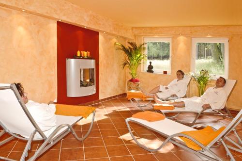 a group of people sitting in chairs in a room at Hotel Waldrausch in Hahnenklee-Bockswiese
