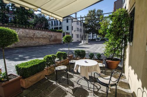 a patio with a table and chairs on a street at Ai Due Fanali Adults Only in Venice