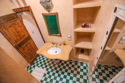 a small bathroom with a sink and a mirror at Riad Anya & SPA in Marrakech