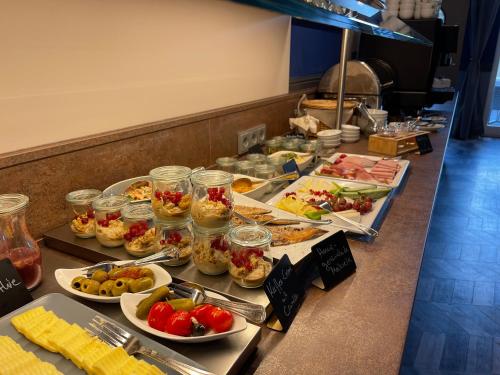 a buffet line with many different types of food at Stadthotel-Garni Smutje in Norden