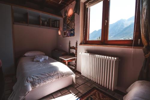 une chambre avec un lit et une fenêtre dans l'établissement Villetta Periax - Affitti Brevi Italia, à Champoluc