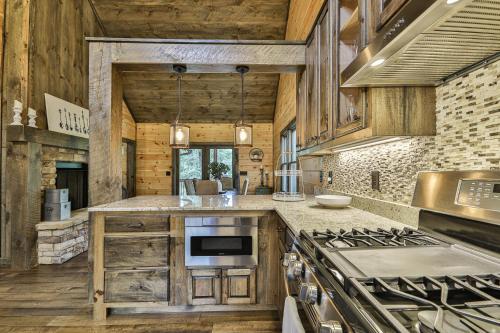 a kitchen with wooden cabinets and a stove at Highlands Retreat the Perfect Cabin for your relaxing experience in Mineral Bluff