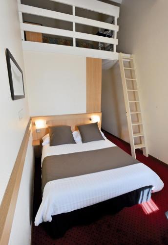a bedroom with a bunk bed and a ladder at Kyriad Rennes Sud - Cesson Chantepie in Chantepie