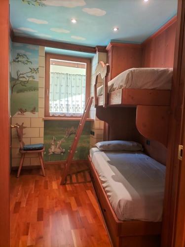 a room with two bunk beds and a window at Il nido incantato in Andalo
