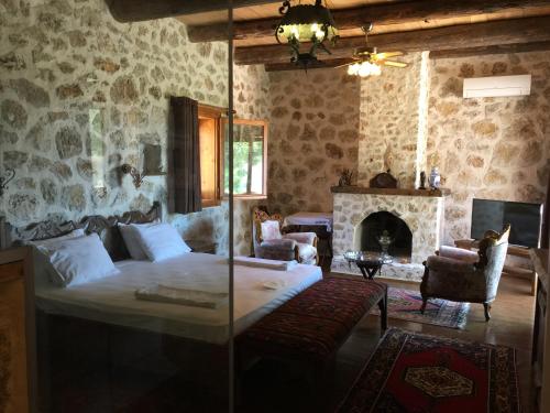 a bedroom with a bed and a fireplace at Beso Patara in Patara