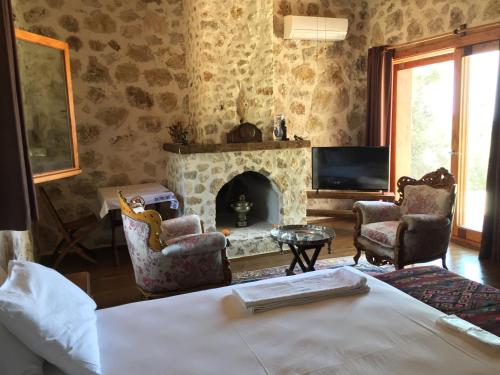 a bedroom with a fireplace and a bed and a tv at Beso Patara in Patara