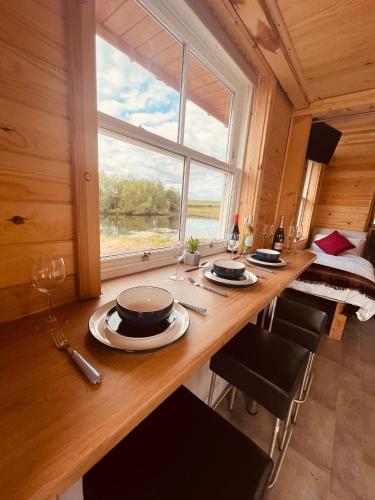 a dining room with a table and a large window at East Learmouth Lakeside Lodges in Cornhill-on-tweed