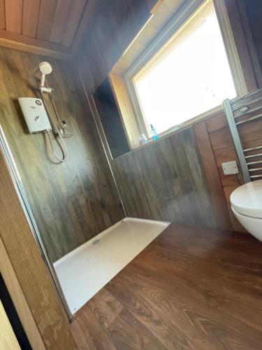 a bathroom with a shower and a toilet at East Learmouth Lakeside Lodges in Cornhill-on-tweed