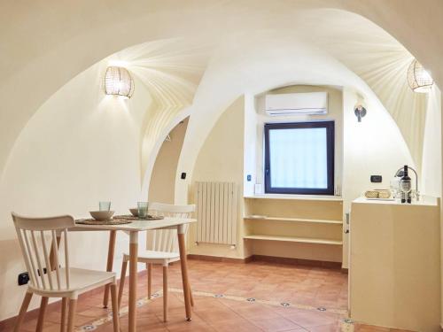 a kitchen and dining room with a table and chairs at Blu Bari in Bari