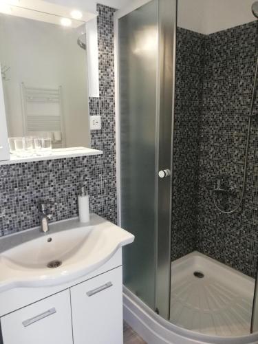 a bathroom with a sink and a shower at Casa Ago - Guest House in Păuliş