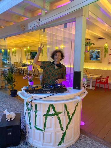a woman standing in front of a dj table at Alpenhotel Stefanie in Mayrhofen