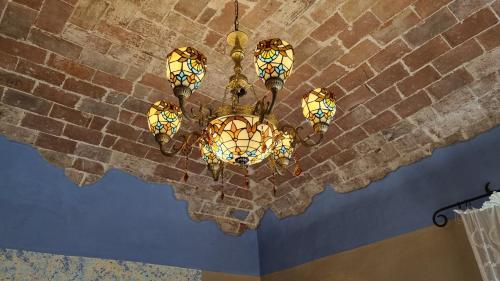 a chandelier hanging from a brick wall at La Terrazza nel cuore di Capoliveri in Capoliveri