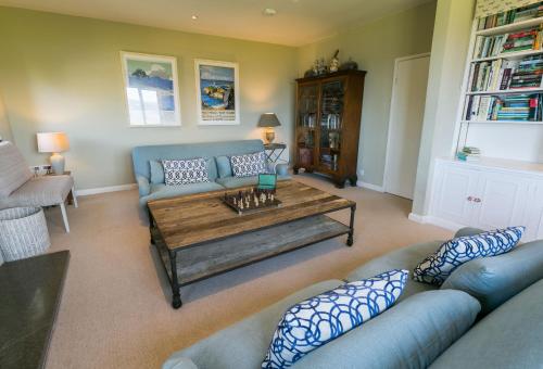 a living room with a couch and a coffee table at Cae'r Borth in Moelfre