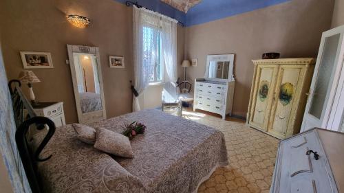 a bedroom with a bed and a dresser at La Terrazza nel cuore di Capoliveri in Capoliveri