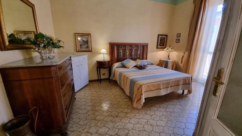 a bedroom with a bed and a dresser in it at La Terrazza nel cuore di Capoliveri in Capoliveri