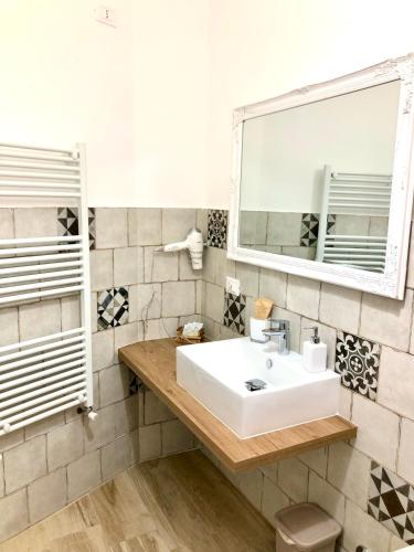 a bathroom with a sink and a mirror at B&B AcquaViva in Marina San Vito