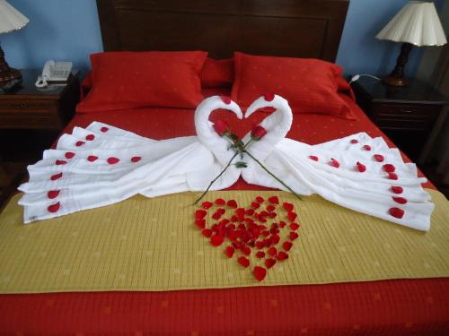 a bed with two swansrendered to look like hearts at Hotel Victoria Plaza in Tarija