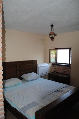 a bedroom with a large bed and a window at Beachfront villa Kakrc in Tivat