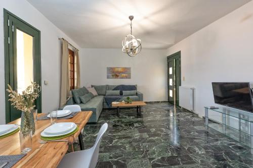 a living room with a couch and a table at A&S Seaside House in Lixouri