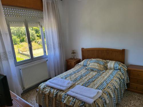 a bedroom with a bed with two towels on it at HOSTAL BARCELONA in Entrimo