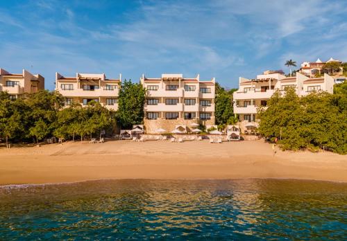 a view of a resort from the beach at Celeste Beach Residences Huatulco Curamoria Collection in Santa Cruz Huatulco