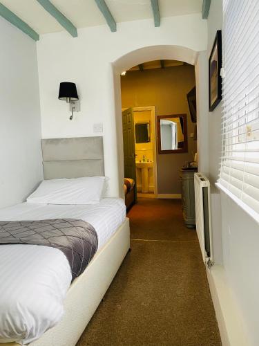 a bedroom with a bed in a room at Molesworth Arms in Wadebridge