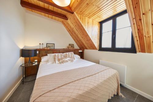 a bedroom with a large bed in a room with wooden ceilings at Mirador de Chisten in Gistaín