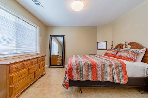 a bedroom with a bed and a dresser and a window at Balboa Rendezvous in McKinleyville