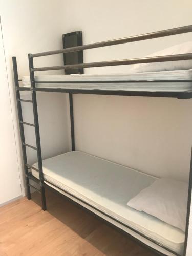 a group of bunk beds in a room at Studio 2 adultes 2 enfants Sanary sur Mer à 800m de la mer in Sanary-sur-Mer