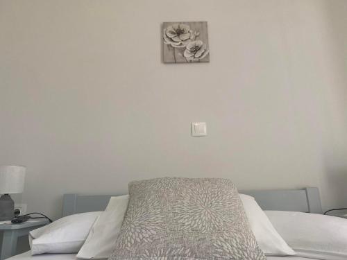 a bedroom with a bed and a picture on the wall at Stelios Zalonis Apartments in Tinos Town