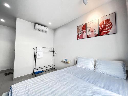 a bedroom with a bed and two pictures on the wall at New Hotel in Rach Gia