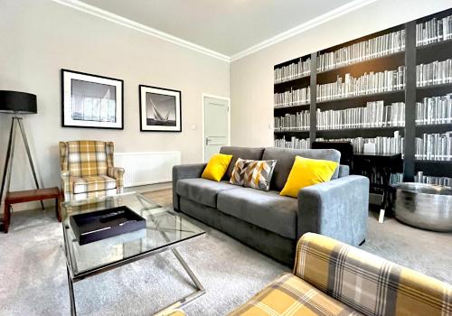 a living room with a couch and a table at Mode Apartments St Annes in Lytham St Annes