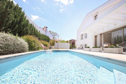 a swimming pool in the backyard of a house at Santa Joana Apartments with garden and heated pool in Lisbon