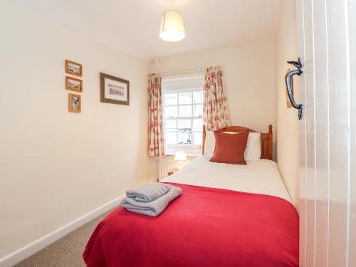 - une chambre avec un lit rouge et blanc et une fenêtre dans l'établissement Stone Ledges, à Keswick