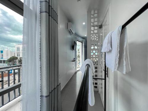 a balcony with towels hanging from a window at New Hotel in Rach Gia