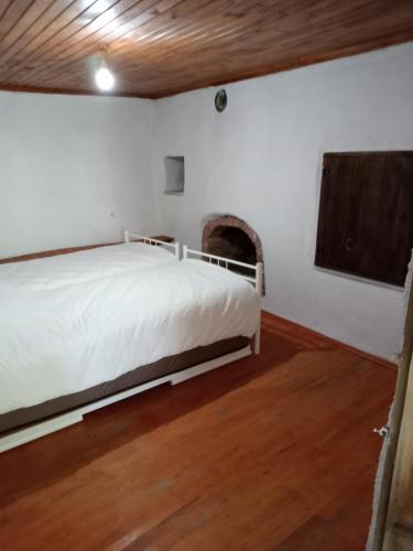 a bedroom with a bed and a fireplace at Koca Kapı Konaklama in Yeşilova